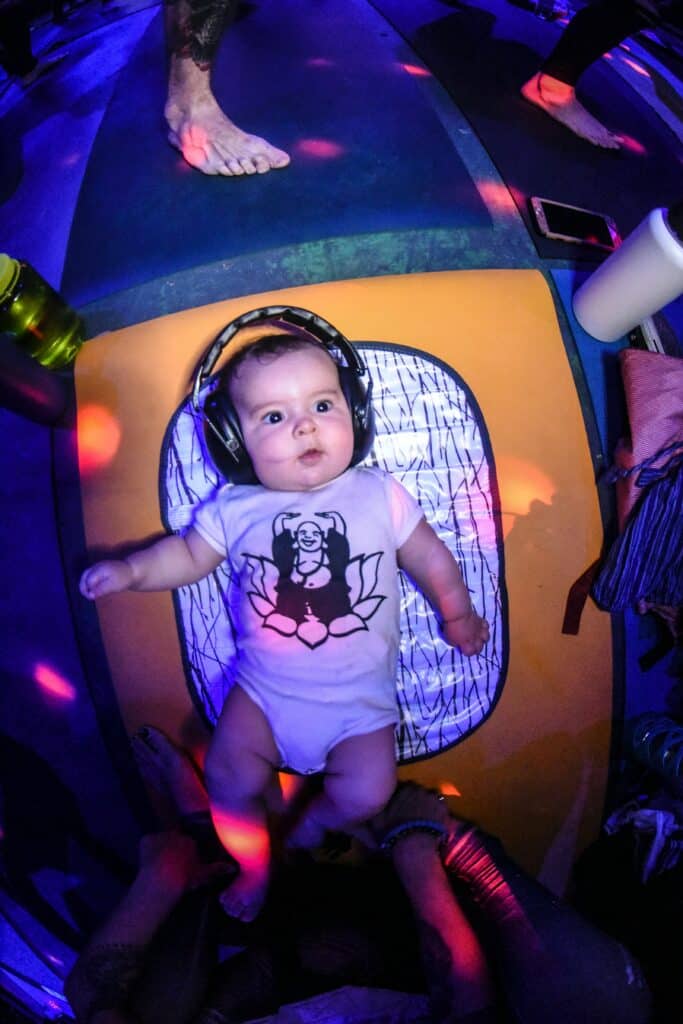 Baby wearing headphones under concert lights