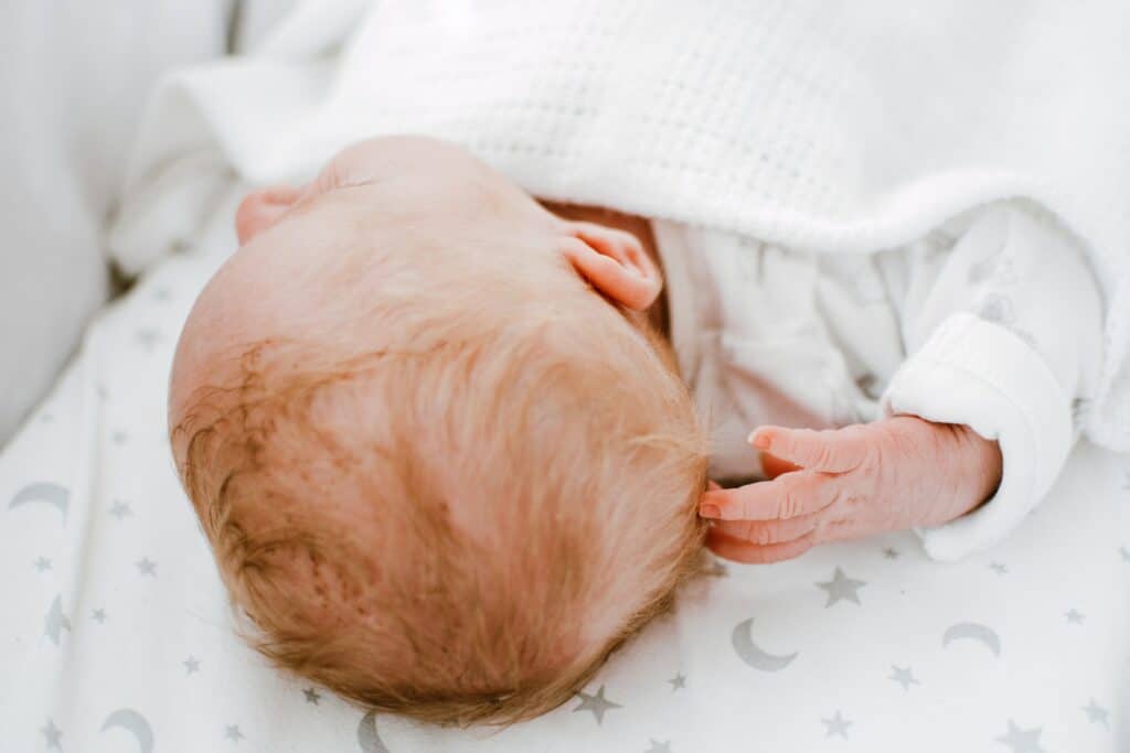 Infant resting in a crib