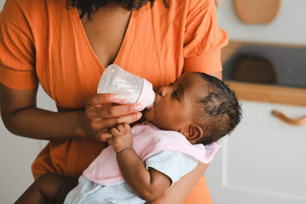 Mom feeding baby from bottle