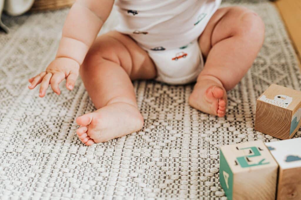 Baby playing on carpet