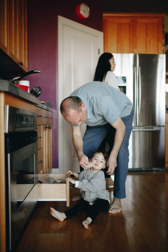 Father cleaning up toddler with baby wipes