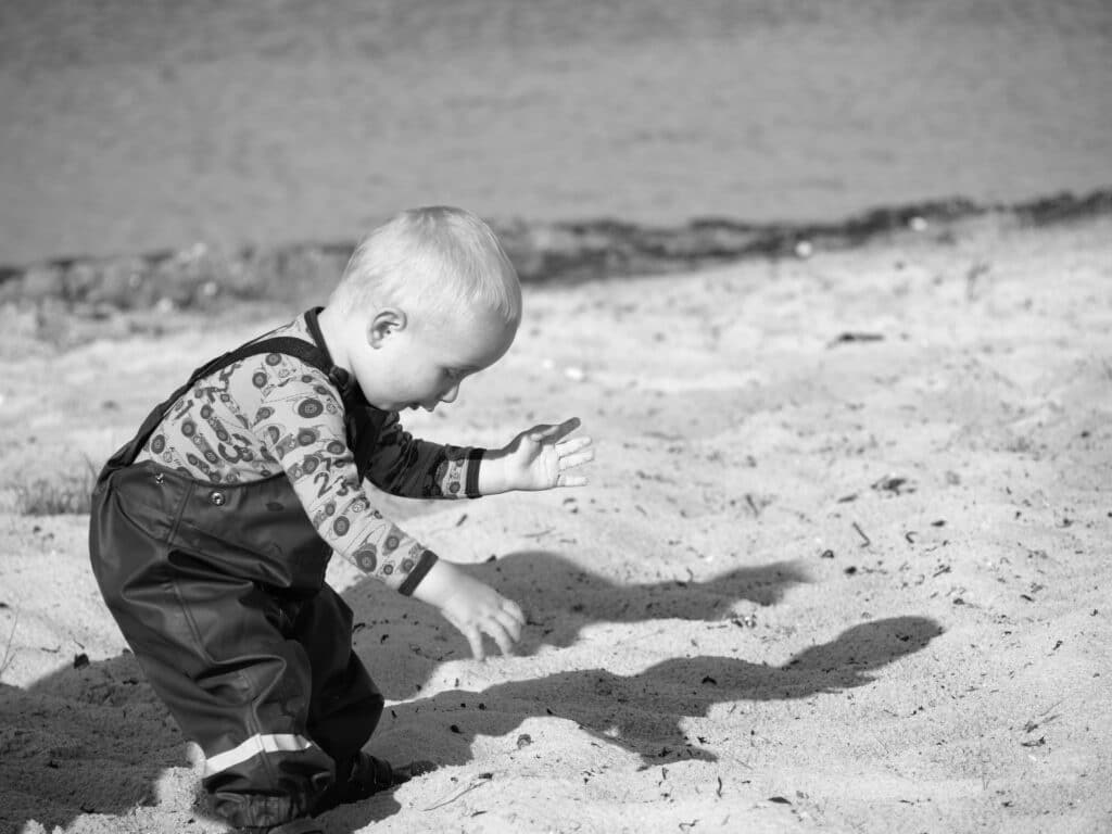 Baby playing in sand at a beach