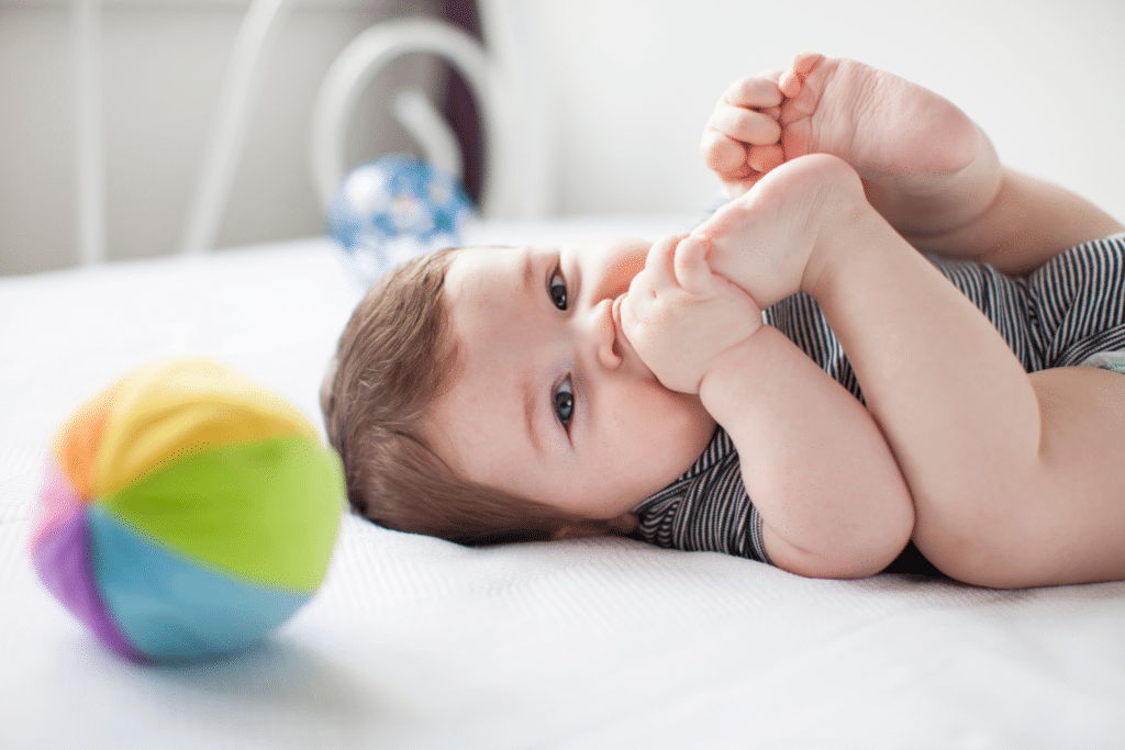 A cute baby about to let out a big fluff! But, why do my baby farts stink?