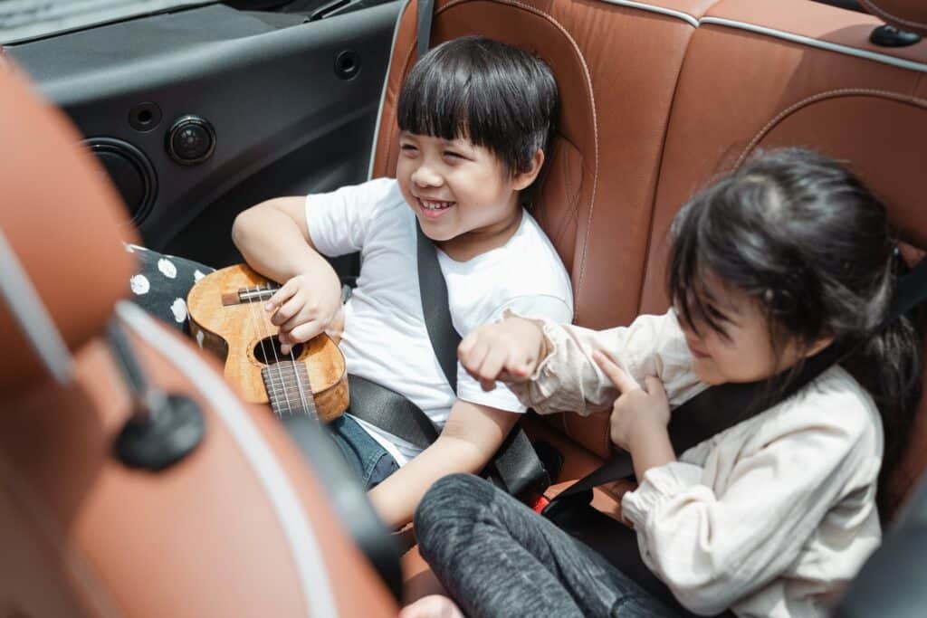 Kids sitting in car with leather seats