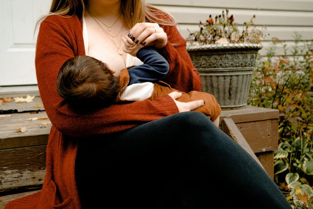 Mom breastfeeding baby on a bench