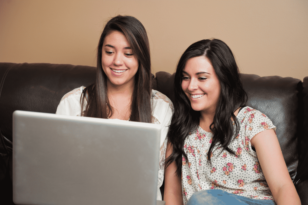 Two women looking at baby pictures on the computer