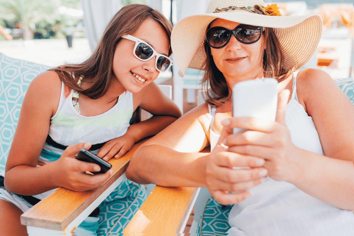 Mom and daughter looking at baby pictures on their phone