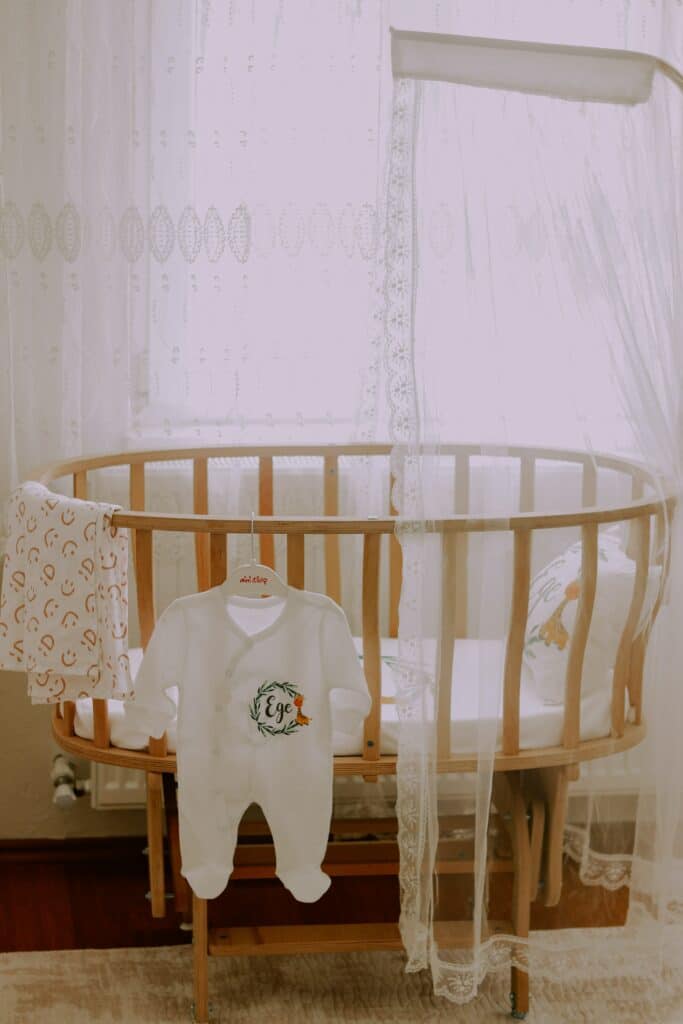 Baby crib in front of a window