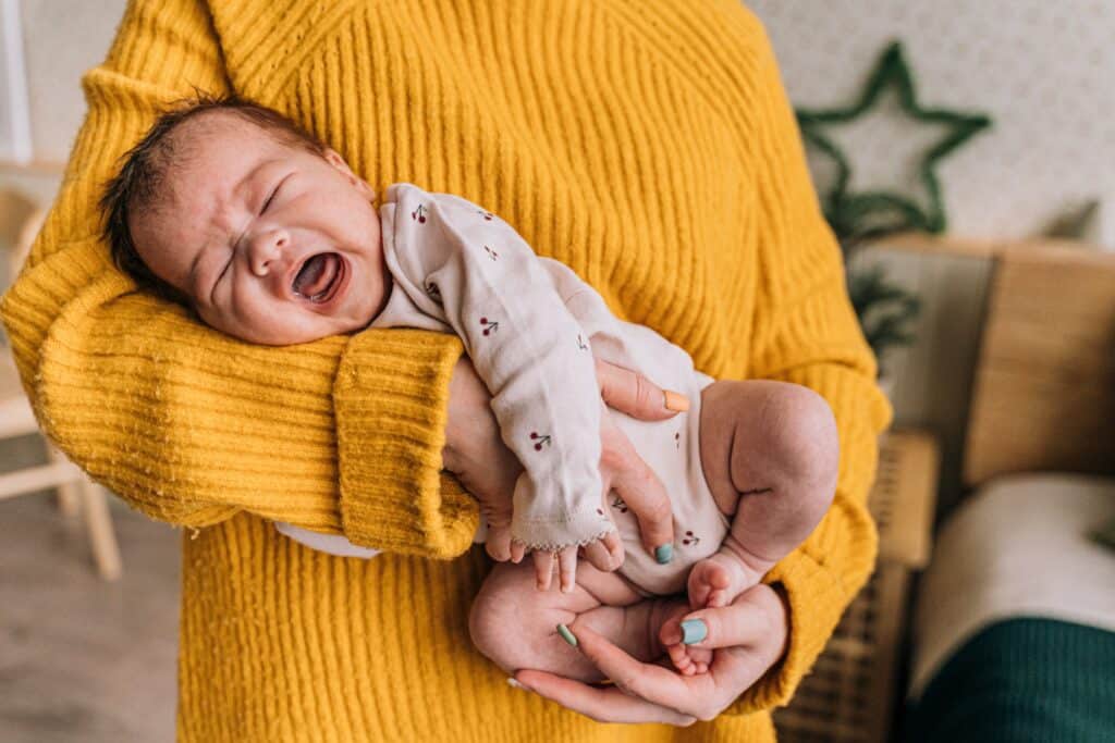 Small baby crying while being held