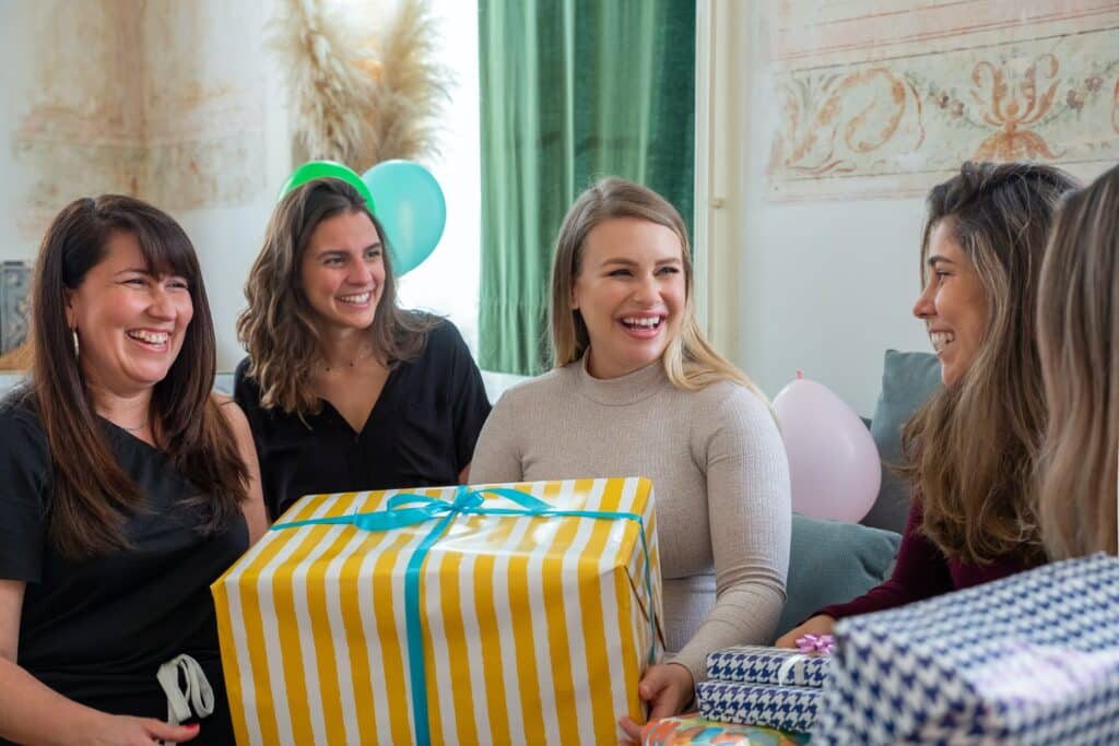 Woman opens baby shower gifts