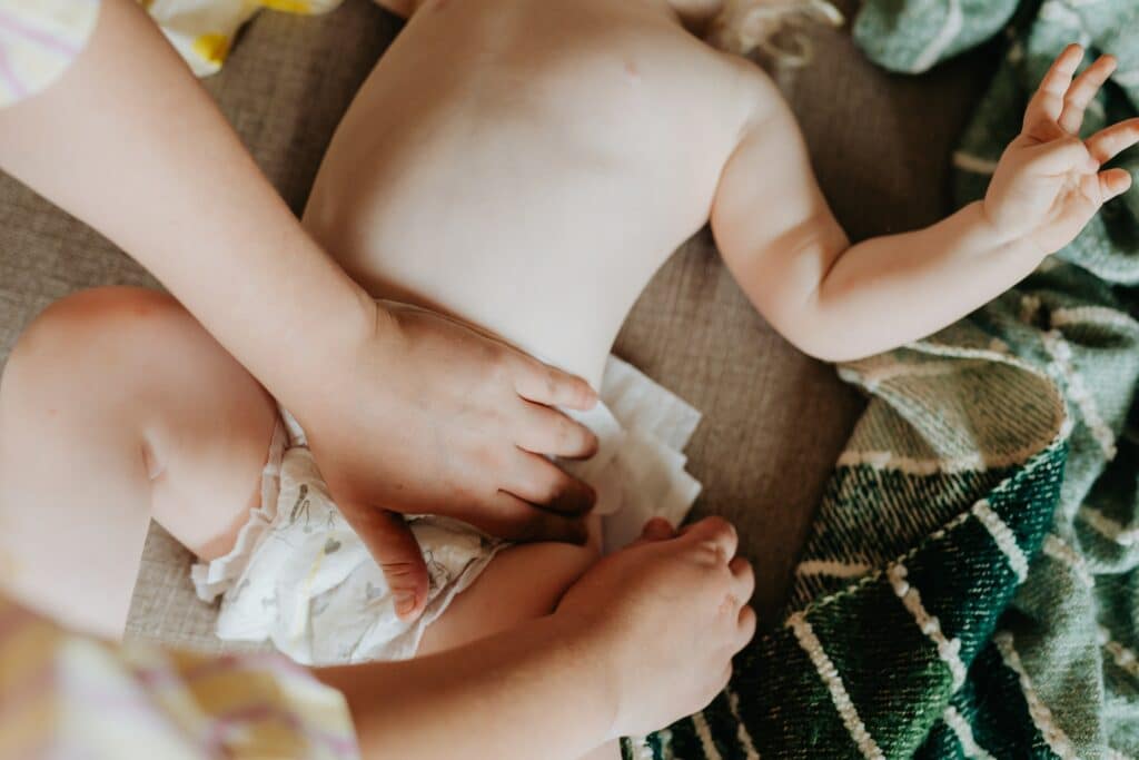 Caregiver changing a baby's diaper