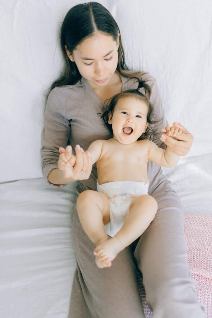 Woman holding a baby's hands