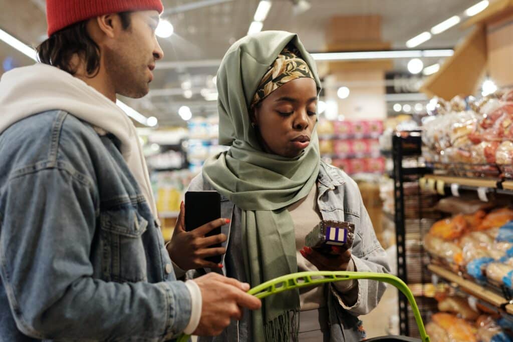 Man and woman shopping at a grocery store for bread