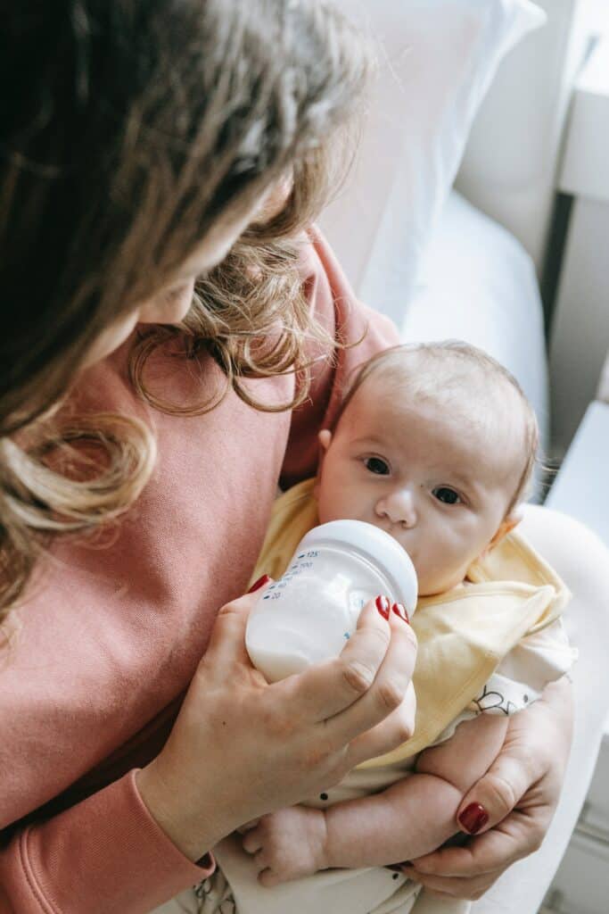 Mother feeding a bottle to a newborn baby