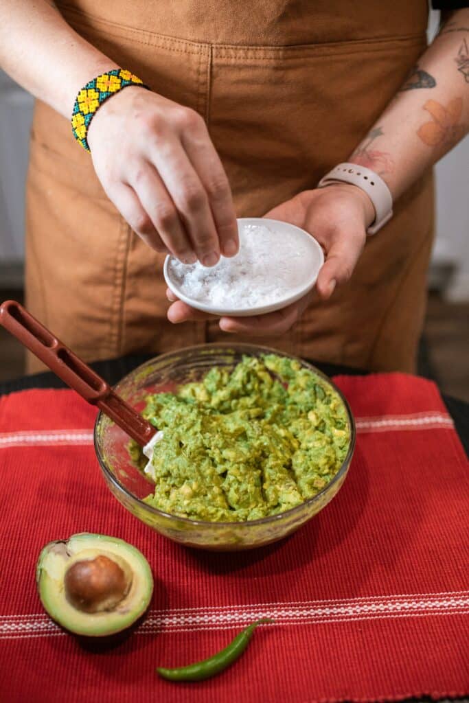 Person preparing fresh guacamole
