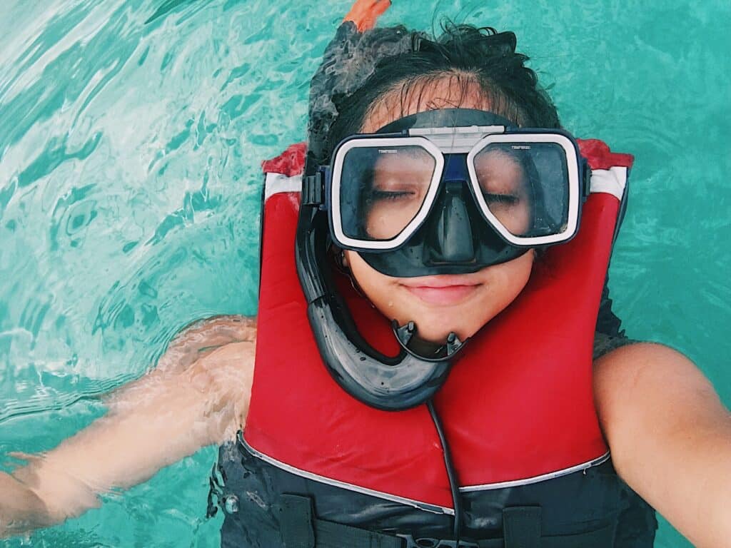 woman snorkeling in life jacket
