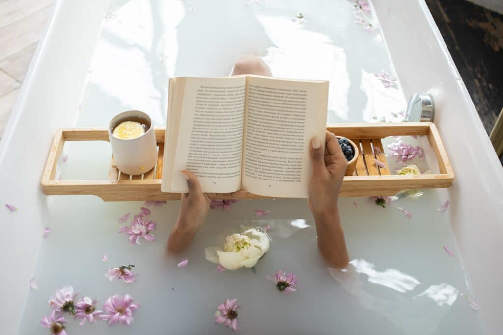 woman reading a book in a bath