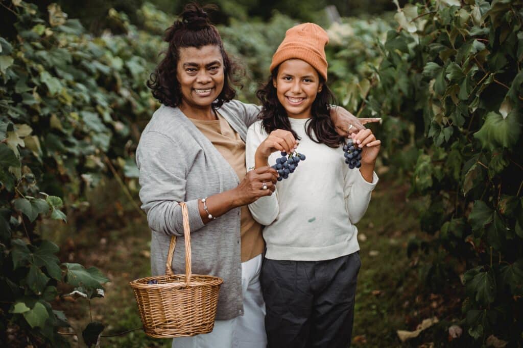 mother with step child picking grapes